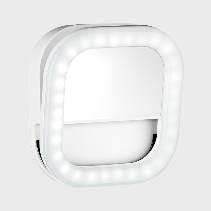 A square LED lighted mirror mounted on a wall, glowing brightly, with a sleek, modern design.