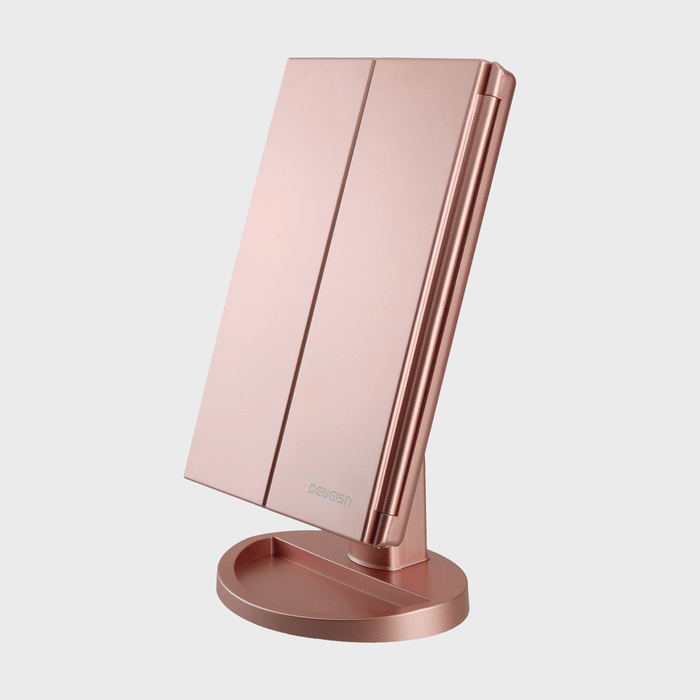 Mirror tilts on a rose gold stand with a white background. Text reads 