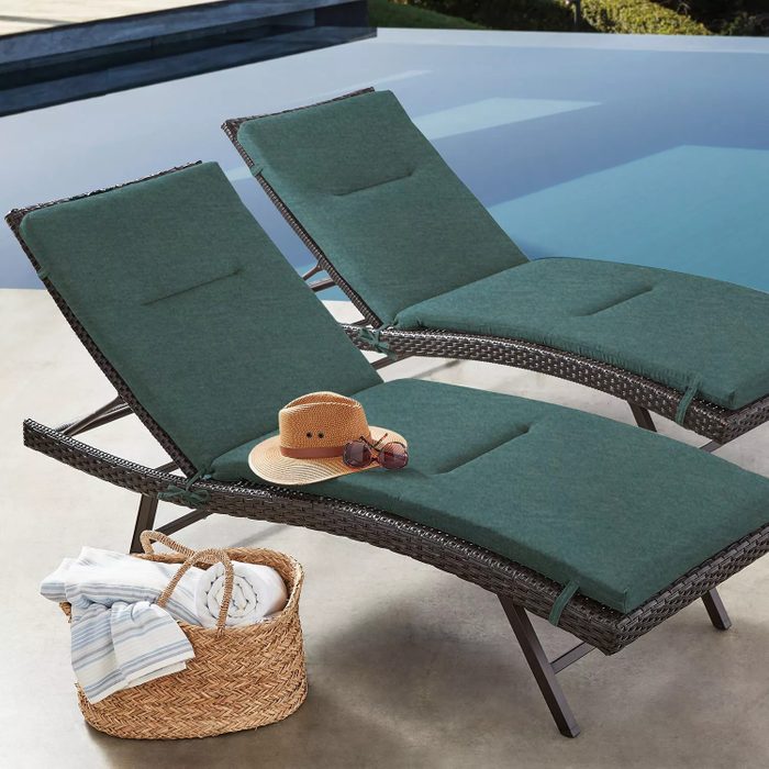 Lounge chairs sit by a pool, with a hat and sunglasses on one. Nearby, a woven basket holds towels.