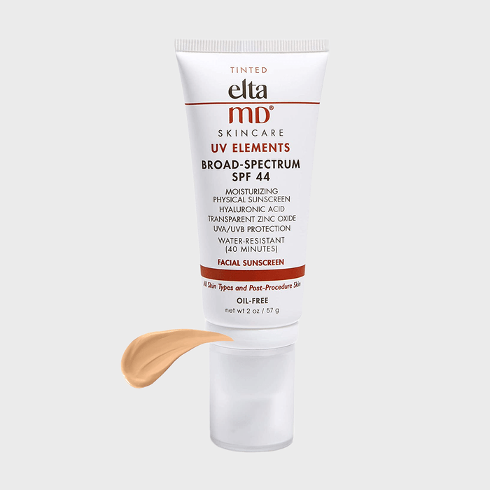 Tube of tinted facial sunscreen stands upright; SPF 44, oil-free, broad-spectrum, moisturizing. Beige swatch shown. White background enhances focus.
