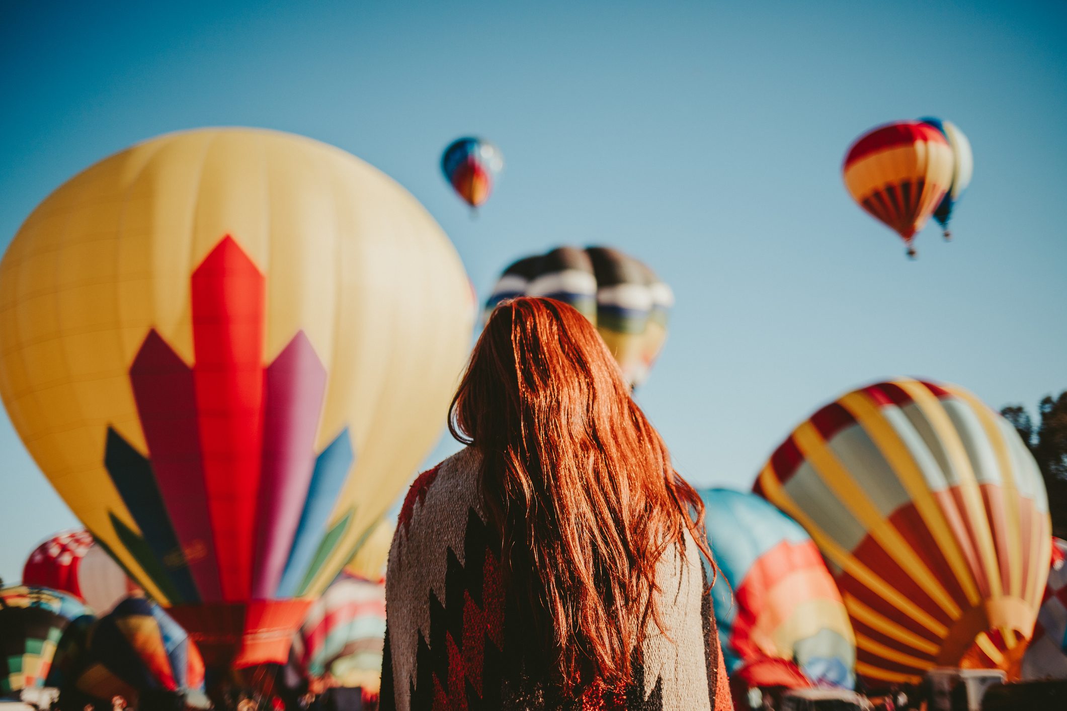 Woman watching hot air balloons