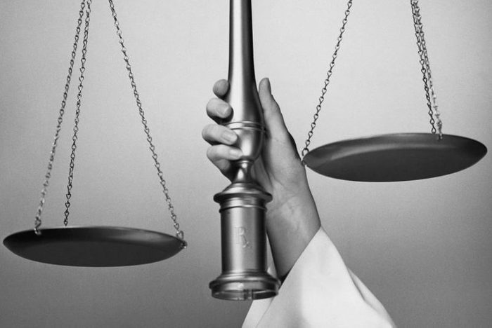 MAN HOLDING SCALE OF JUSTICE