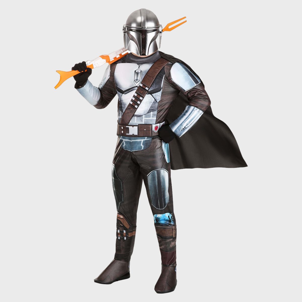 A person is wearing a metallic sci-fi costume, holding a toy weapon, against a plain backdrop.