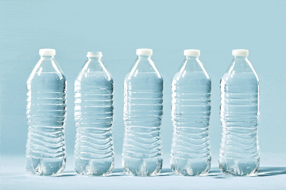 five clear plastic water bottles in a row with a vine growing out of one, blue background