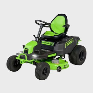 A green ride-on lawnmower is stationary, featuring a steering wheel and labeled 