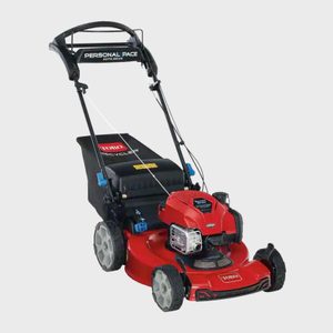 Red lawn mower stands idle, featuring 