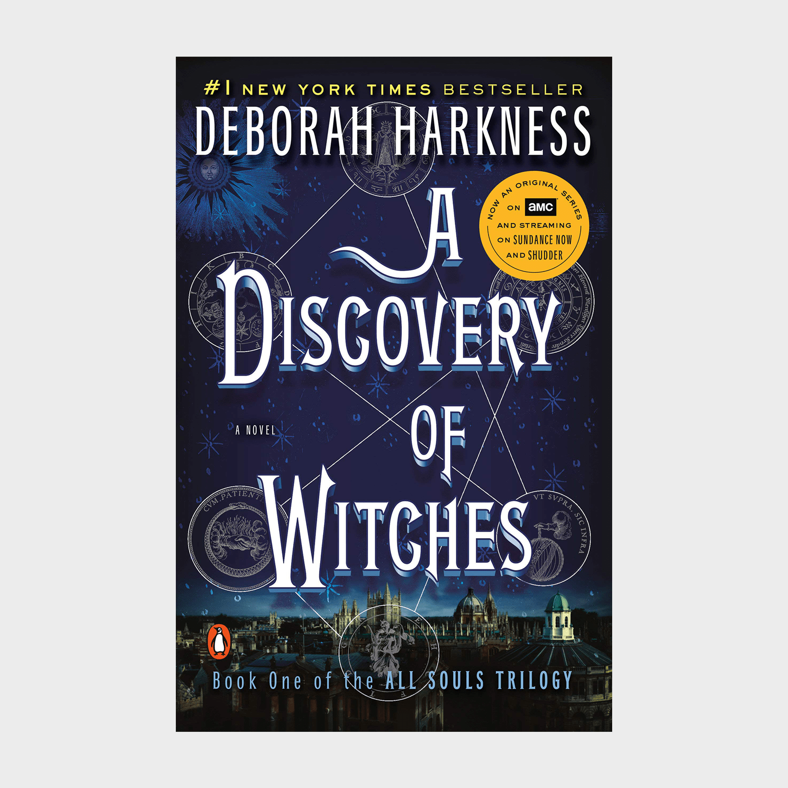 Book cover shows "A Discovery of Witches" by Deborah Harkness, featuring celestial symbols over a nighttime cityscape. Includes "New York Times Bestseller" and AMC series mention.