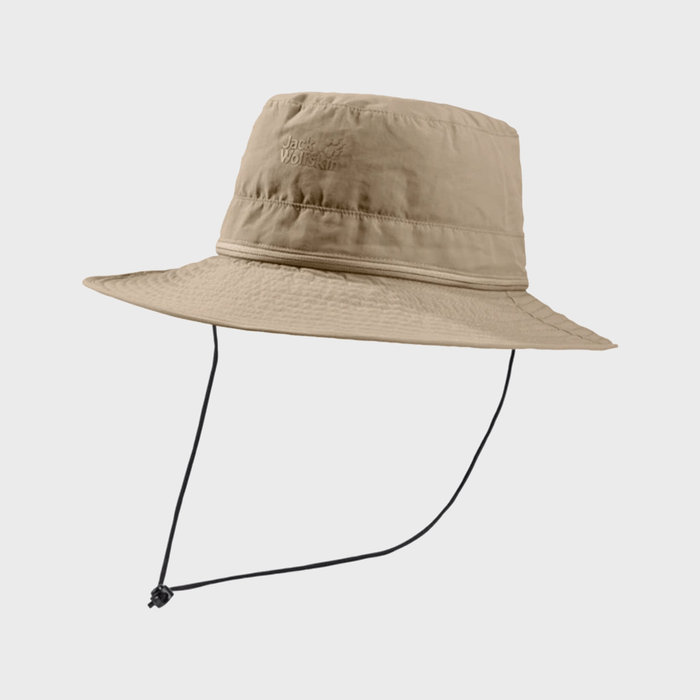 Tan bucket hat with chin cord, suspended against a plain backdrop. Features embroidered 