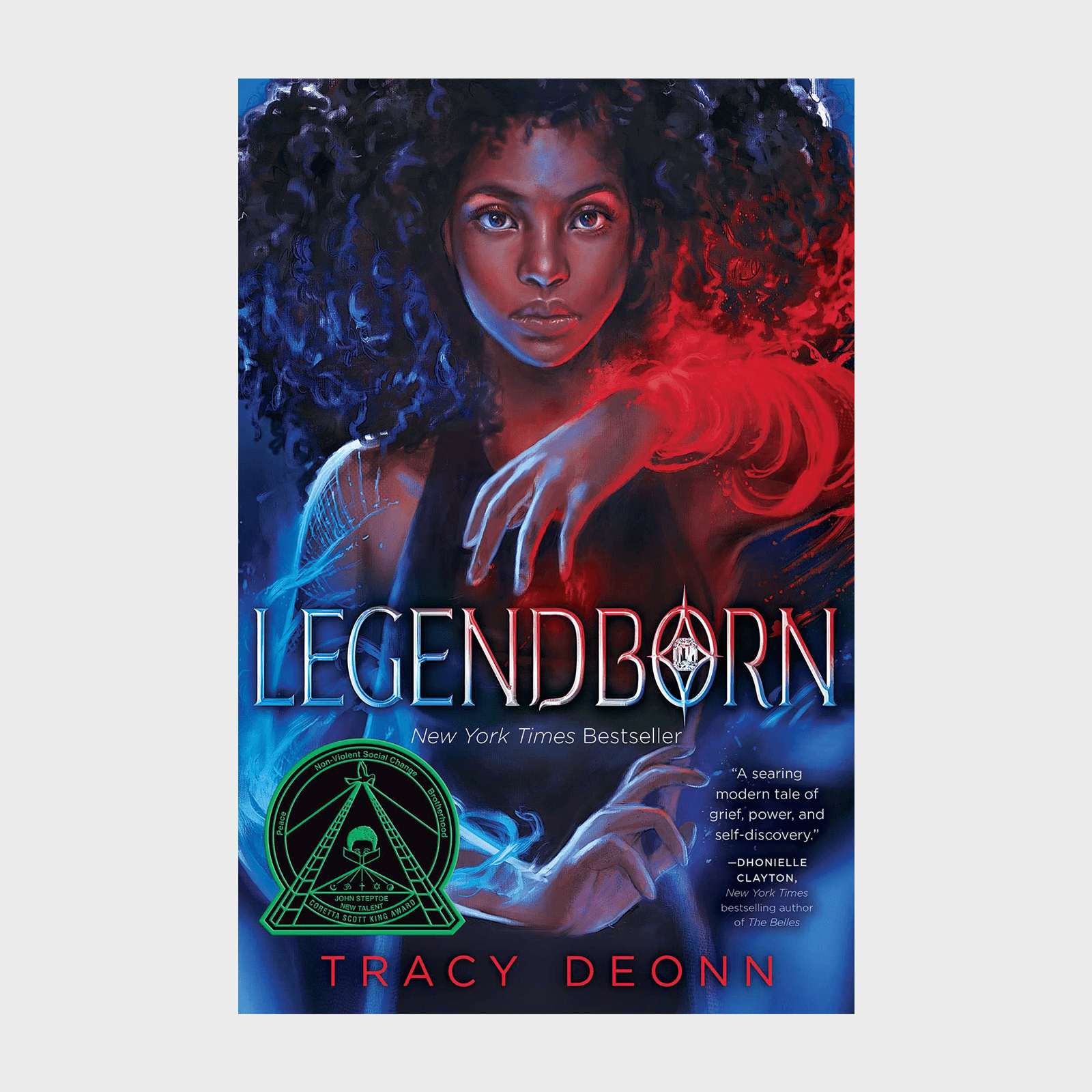 A person stands with glowing red and blue magic, afro hair flowing. Cover text: "Legendborn" by Tracy Deonn; includes a circle emblem.