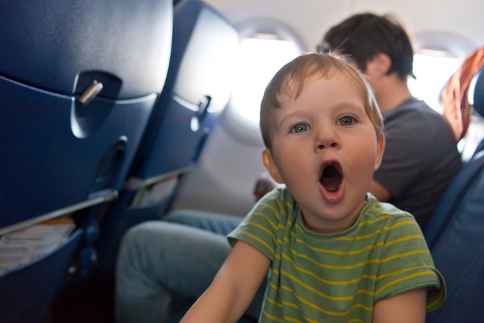 Naughty boy travelling by plane