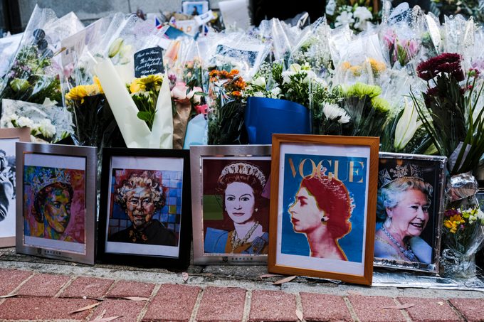 Flowers and tributes are placed on the ground in memory of Queen Elizabeth II outside the British Consulate General Hong Kong on September 16, 2022 in Hong Kong, China. Queen Elizabeth II died at Balmoral Castle in Scotland aged 96 on September 8, 2022, and is survived by her four children, Charles, Prince of Wales, Anne, Princess Royal, Andrew, Duke Of York and Edward, Duke of Wessex. Elizabeth Alexandra Mary Windsor was born in Bruton Street, Mayfair, London on 21 April 1926. She married Prince Philip in 1947 and acceded the throne of the United Kingdom and Commonwealth on 6 February 1952 after the death of her Father, King George VI. Queen Elizabeth II was the United Kingdom's longest-serving monarch. (Photo by Sawayasu Tsuji/Getty Images)