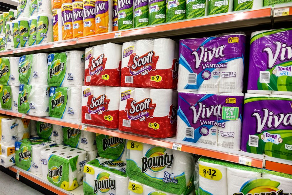 Shelves of paper towels for sale inside Navarro Discount Pharmacy.