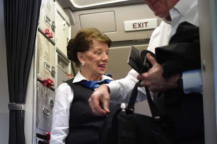 flight attendant greeting passengers