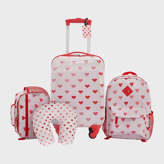 Luggage set featuring a suitcase, backpack, duffel, and neck pillow, all adorned with red heart patterns on a white background.