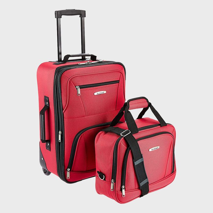 Red luggage set sits stationary, featuring a wheeled suitcase and a carry-on bag, against a plain background.
