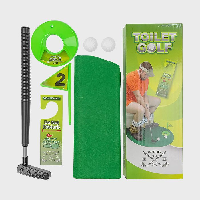 Putter, flag, two balls, green mat; arranged along toilet-themed packaging featuring person sitting, labeled 