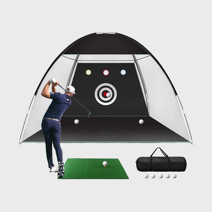 Golfer swings towards practice net with targets; includes mat, carrying bag, and four golf balls; set against a white background.