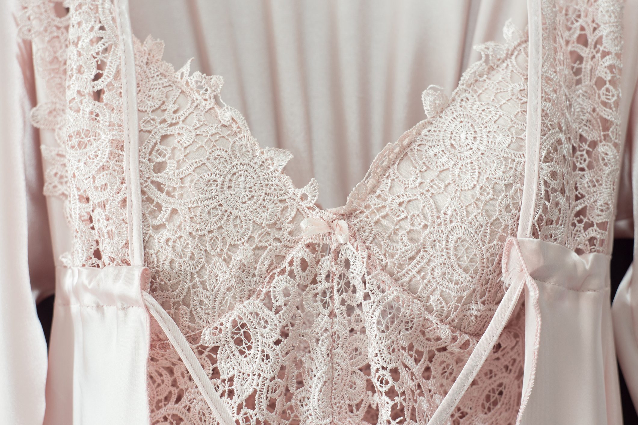 Lace nightgown and cream silk robe on pink background