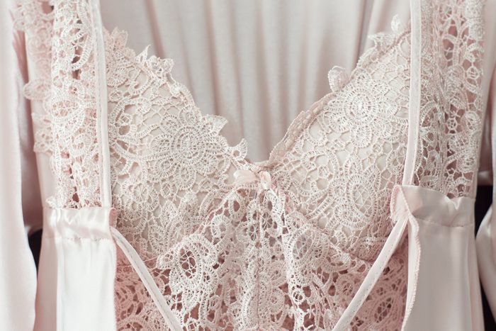 Lace nightgown and cream silk robe on pink background