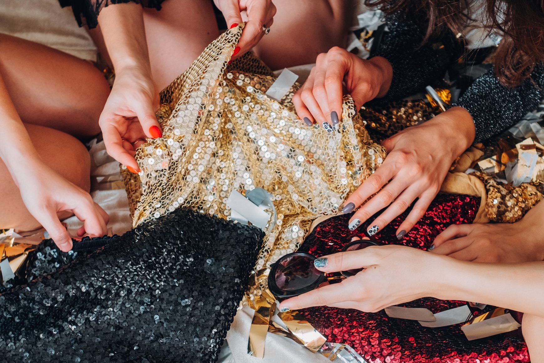hands reaching for sequin clothes