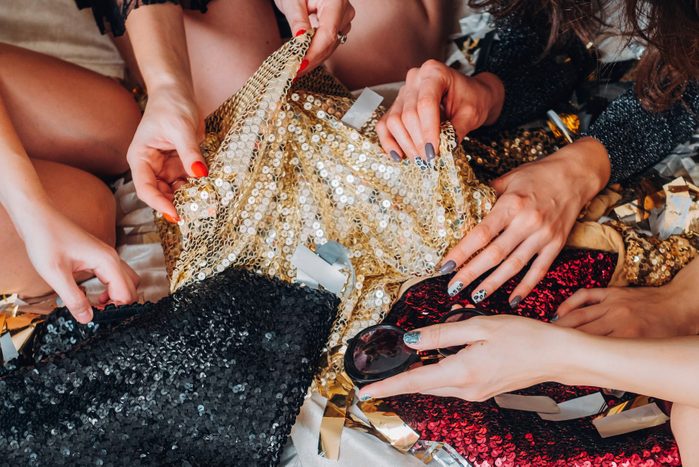 hands reaching for sequin clothes