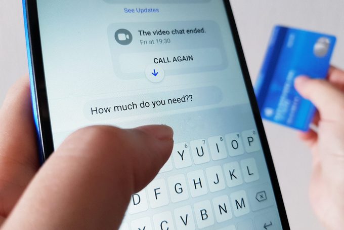 Phone displays messaging app; user types "How much do you need??" while holding a blue credit card in a well-lit room.