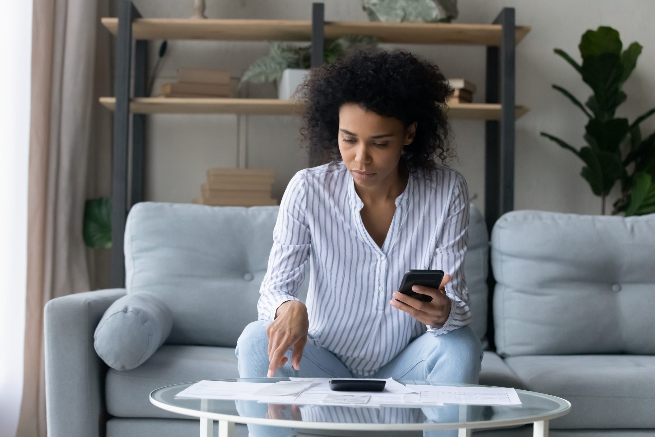 woman checking receipts and using a rebate app after buying groceries