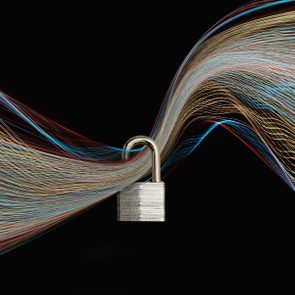 Padlock unlocks amid colorful light trails, set against a dark background.