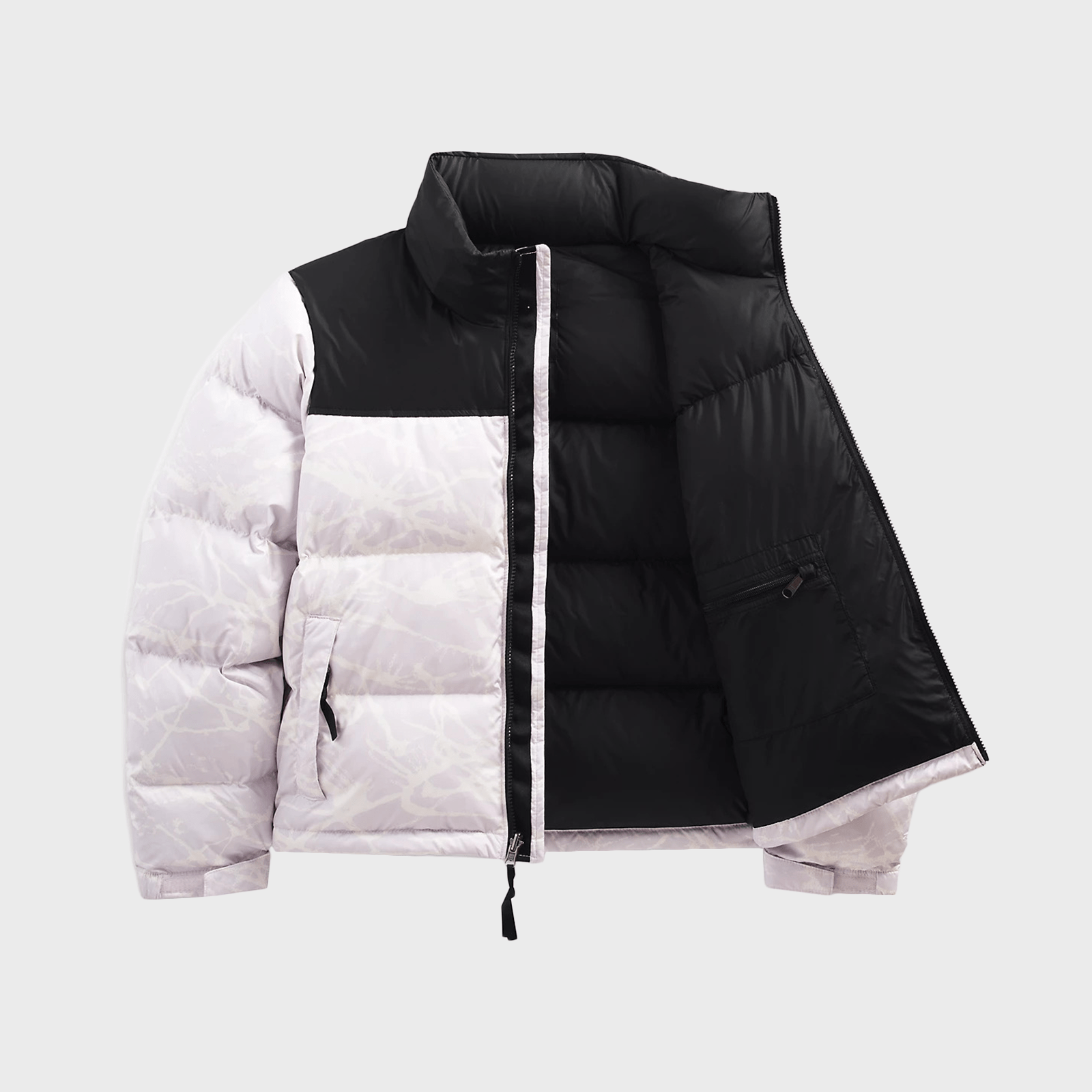 Puffer jacket displayed half-zipped, revealing a black and white color block design against a plain background.