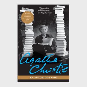 Woman types, holding paper, surrounded by piles of books. Text includes: 