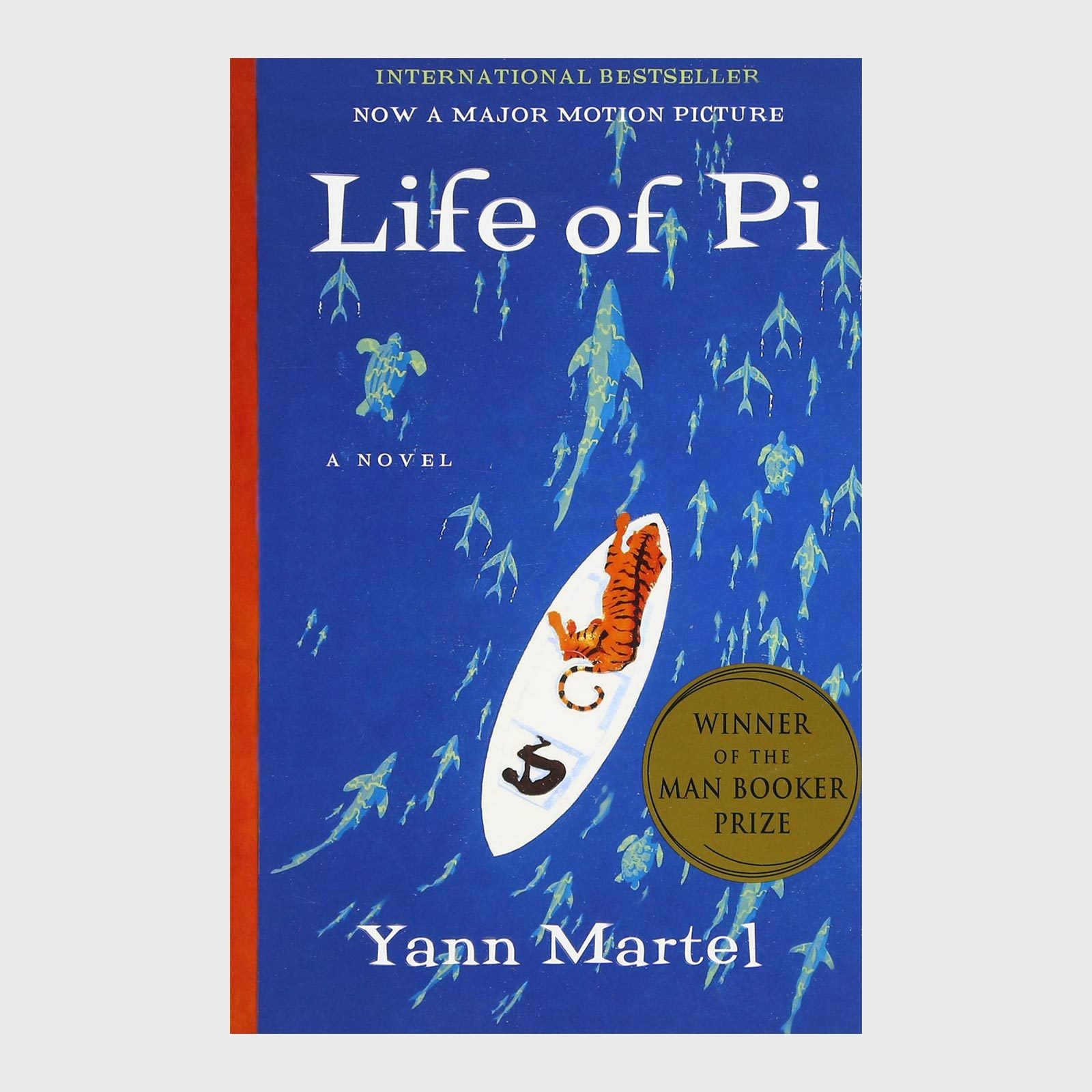 A tiger lies on a boat surrounded by fish silhouettes; text reads "Life of Pi" by Yann Martel.