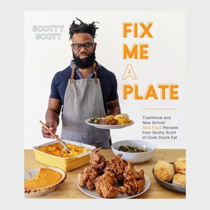 Man holds plate of soul food; stands beside table with cornbread, fried chicken, greens, and pie. Gray apron worn; text mentions 