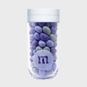 A clear jar holds purple and gray candies with 