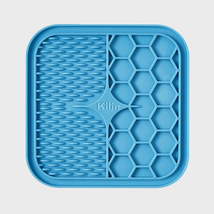 Blue silicone mat features ridges and hexagonal patterns; embossed with 