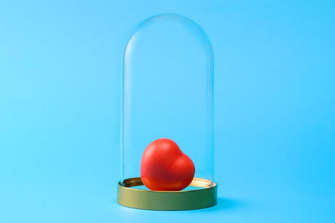 heart in a glass cloche on blue background