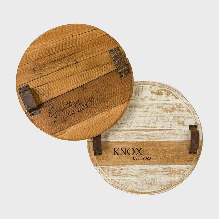 Two wooden barrel lids display engravings. One reads 