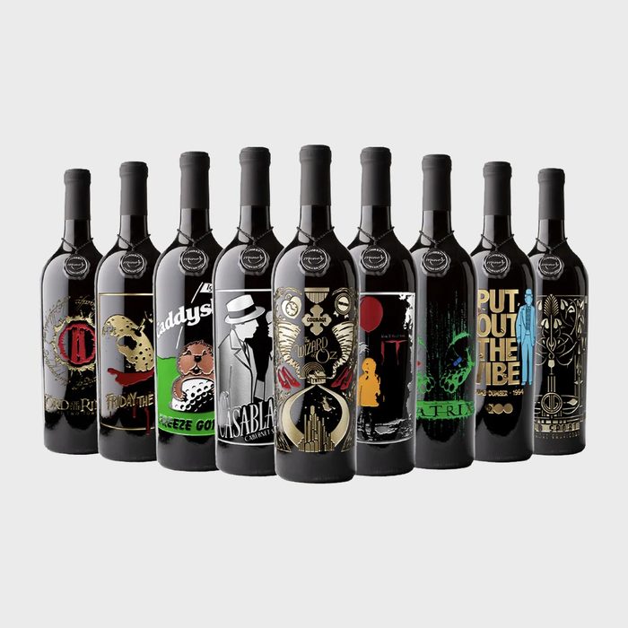 Wine bottles display film-themed labels, standing in a row, featuring iconic movie artwork against a plain background.