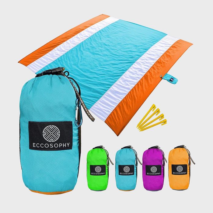 Beach blanket folded in turquoise bag, labeled 