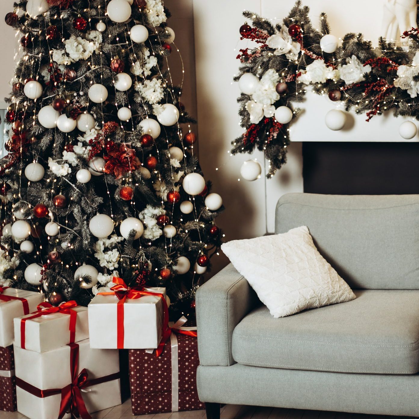 Sofa in xmas room with of gift boxes under new year tree.