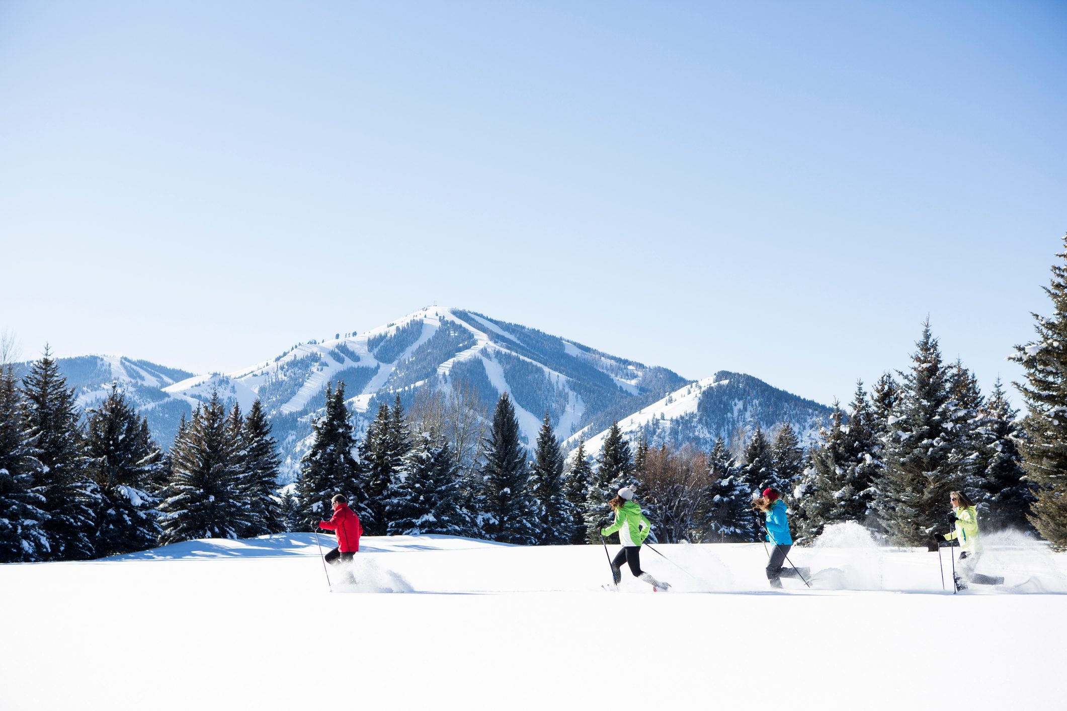 A family Snowshoeing in Sun Valley on a sunny winter day.