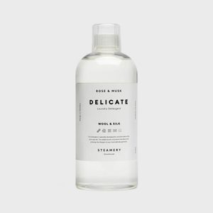 Clear bottle containing liquid, labeled 
