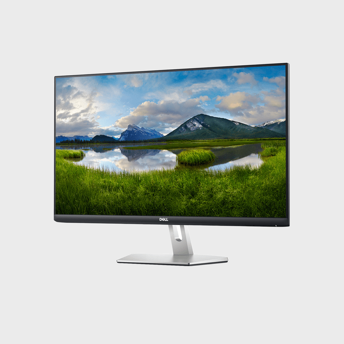 Monitor displays a serene lake and mountain landscape, standing on a sleek silver base in a minimalist setting.