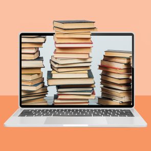 Laptop displays stacks of books in front of a peach-colored background.