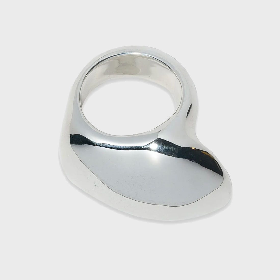 Silver ring sits motionless, showcasing a smooth, abstract design against a plain white background.