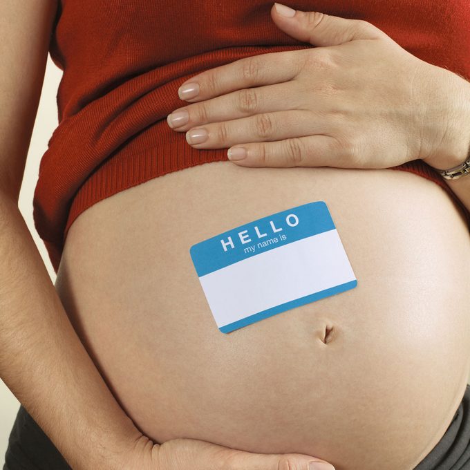 Pregnant Female with a Hello My Name is Sticker on her bellly