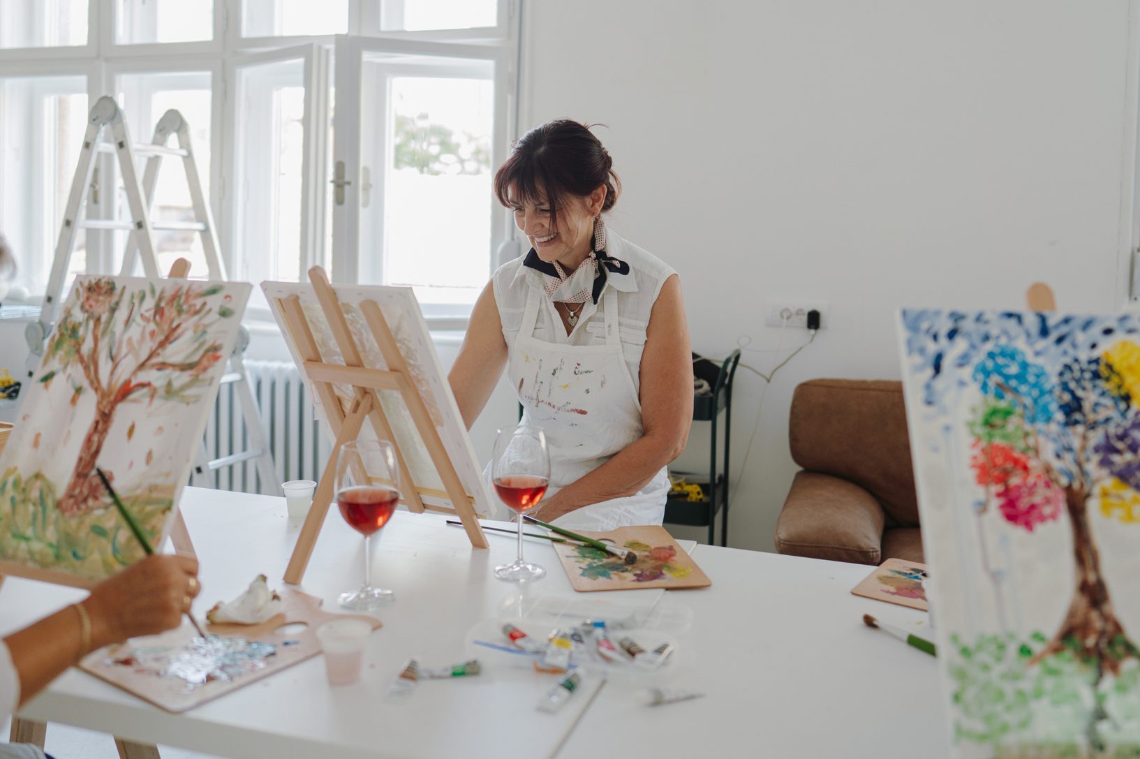 Mature woman painting in art class