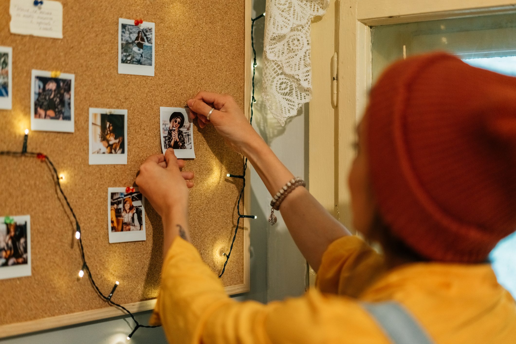 Girl creating collection of instant photo memories