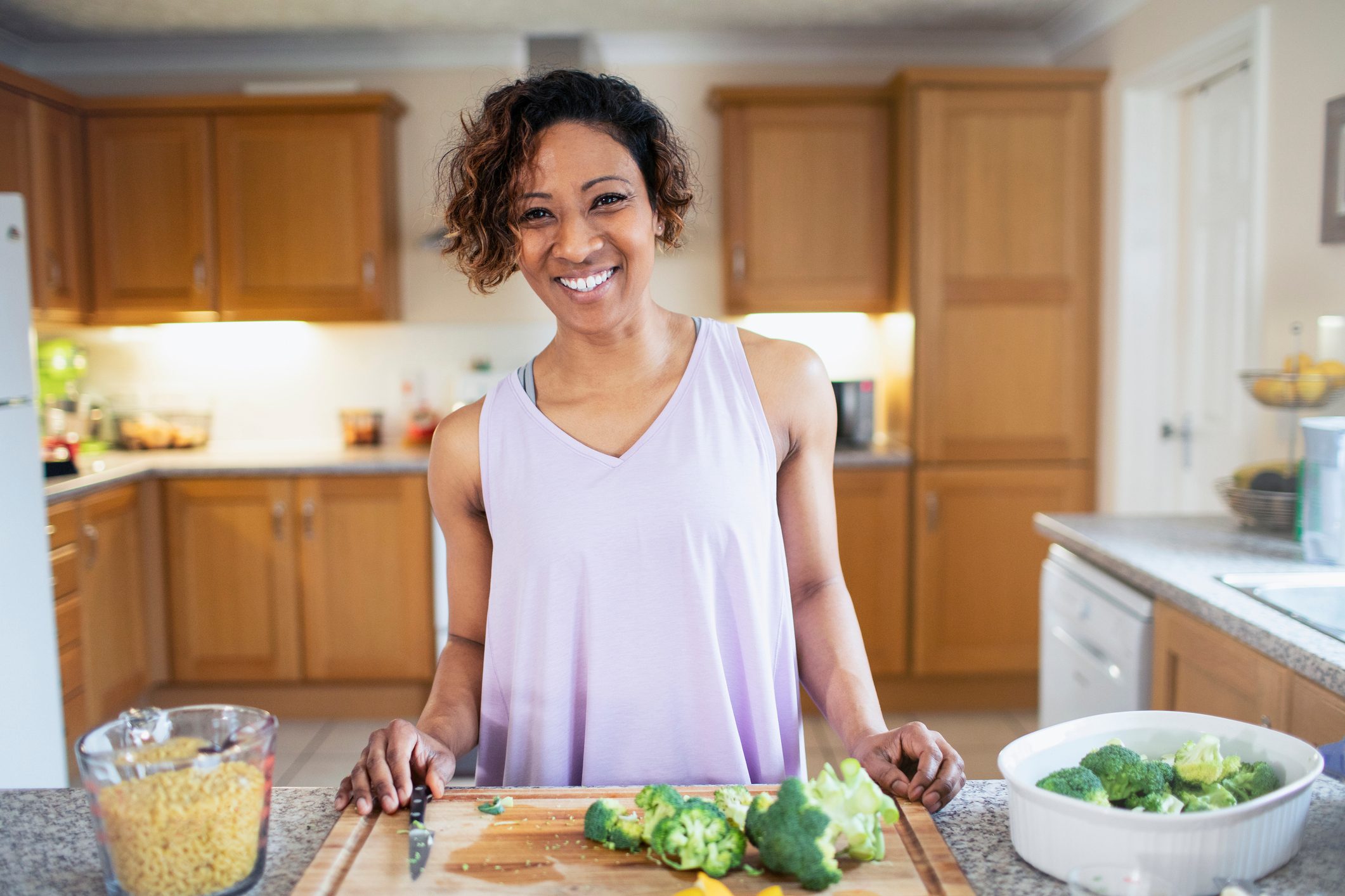 Portrait smiling, confident woman cooking in kitchen