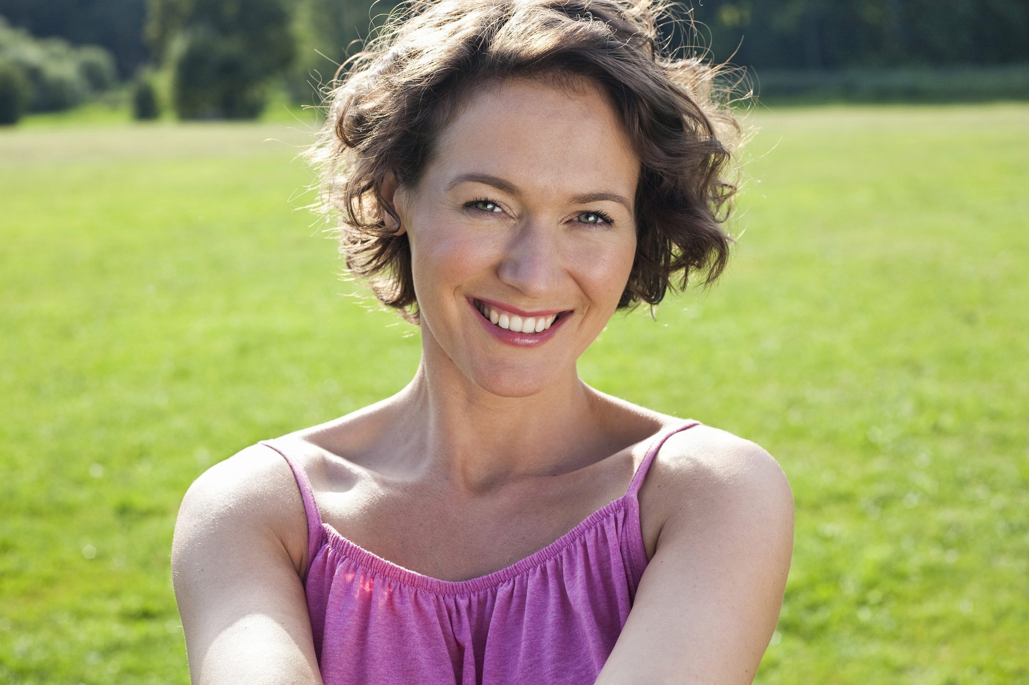 Happy woman in casuals at park