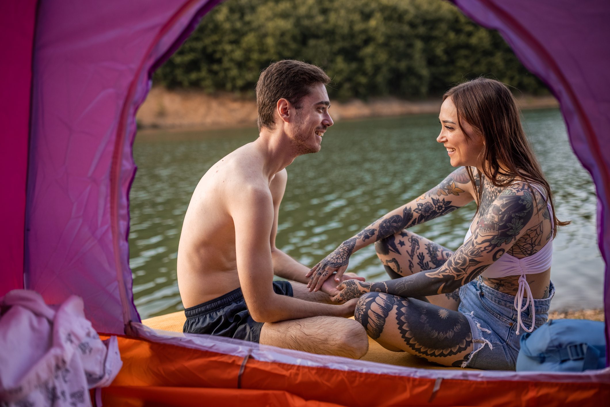 Young Caucasian couple camping near lake